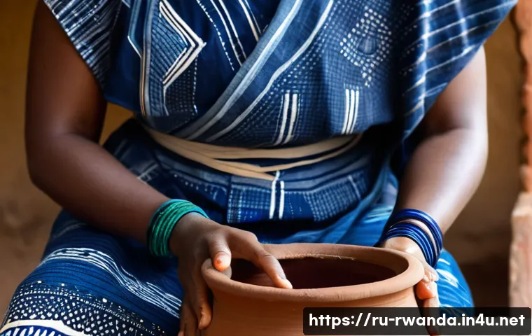 르완다에서의 전통 염색 공예 - A close-up shot of a Rwandan woman's hands, adorned with simple bracelets, gently immersing a piece ...